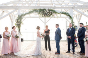 Florida Bride and Groom During Waterfront Dockside Wedding Ceremony Exchanging Vows Under Cabana, Nautical Inspired Decor, White, Ivory, Blush Pink, and Green Floral Arch | Tampa Bay Hotel and Wedding Venue The Godfrey Hotel & Cabanas