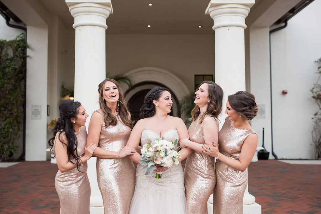 Florida Bride Holding Organic Ivory, White, Blush Pink Floral and Dusty Miller Greenery Bouquet and Bridesmaids in Matching Gold Glitter Sparkly Long Dresses | Tampa Bay Waterfront Wedding Venue Westshore Yacht Club | South Tampa Luxury Wedding Planner NK Productions Wedding Planning