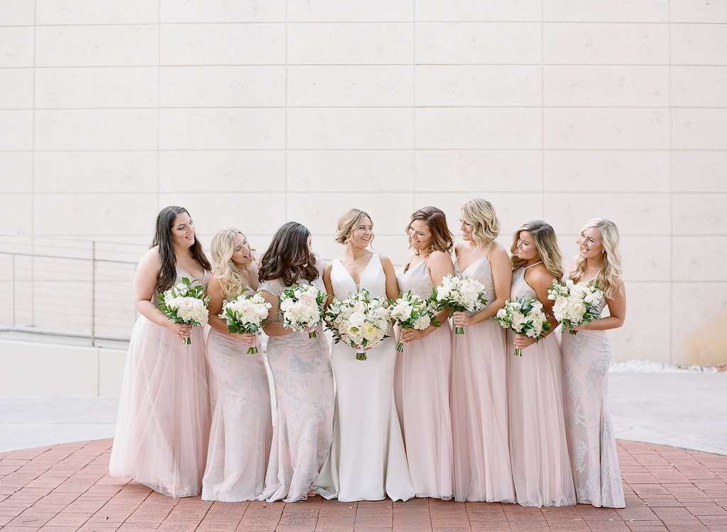 Tampa Bay Bride and Bridesmaids in Hayley Paige Mix and Match Blush Pink Bridesmaids Dresses Holding Classic Garden Inspired White, Ivory, Blush Pink, and Greenery Floral Bouquets