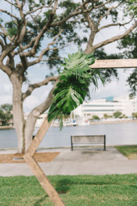 Modern, Simple Outdoor Waterfront Wedding Ceremony Decor, Geometric Wooden Arch with Tropical Monstera Palm Leaves | Wedding Photographer Kera Photography | St. Petersburg Wedding Venue The Poynter Institute