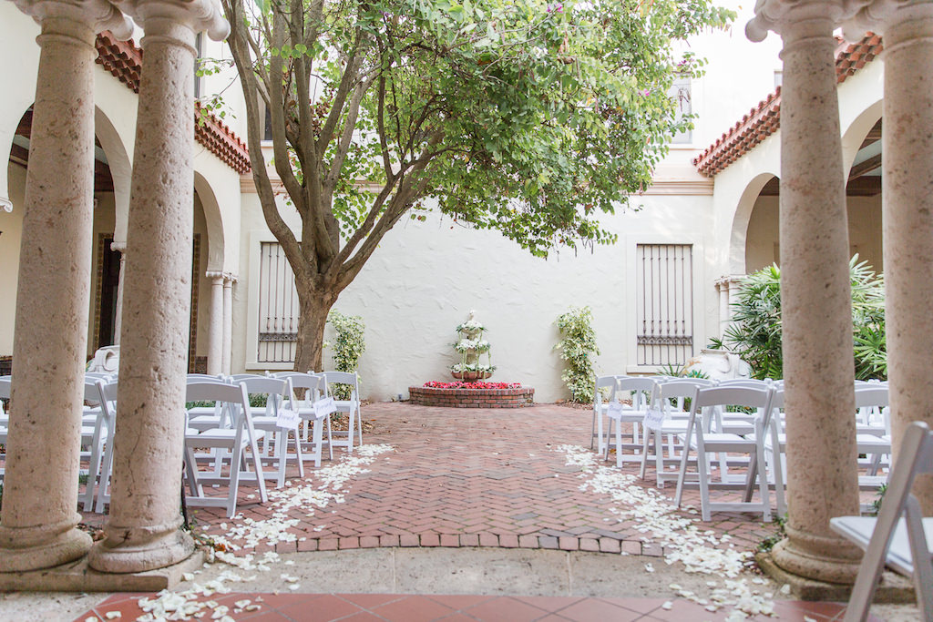 Outdoor Courtyard Classic Wedding Ceremony Decor, White Folding Chairs, White Rose Petals, Fountain with Garden Inspired Floral Arrangements | St. Petersburg Wedding Venue Museum of Fine Arts