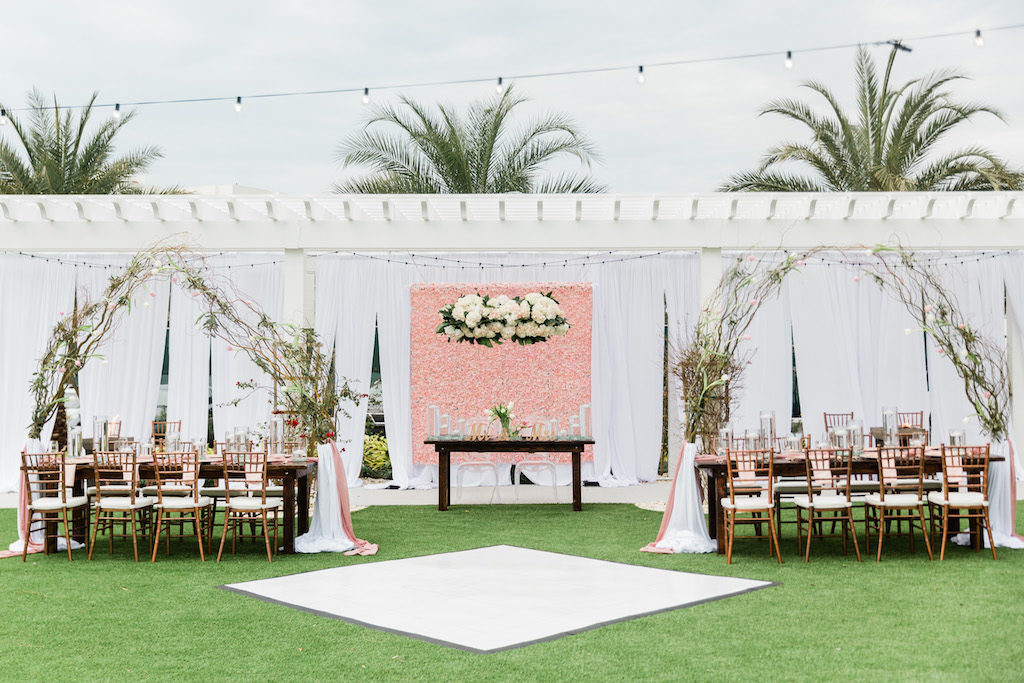Modern, Whimsical Garden Wedding Decor and Reception under Gazebo, Pink Floral Boxwood Wall, White Draping, Hanging Floral Arrangement, Long Feasting Tables. Rose Gold Chiavari Chairs, Feasting Tables, Arching Thistle and Stems Arrangement, Sweetheart Table with Ghost Acrylic Chairs, Outdoor Dance floor | Tampa Bay Wedding Planner Special Moments Event Planning | Tampa Bay Wedding Florist and Rentals Gabro Event Services | Tampa Bay Wedding Rentals A Chair Affair