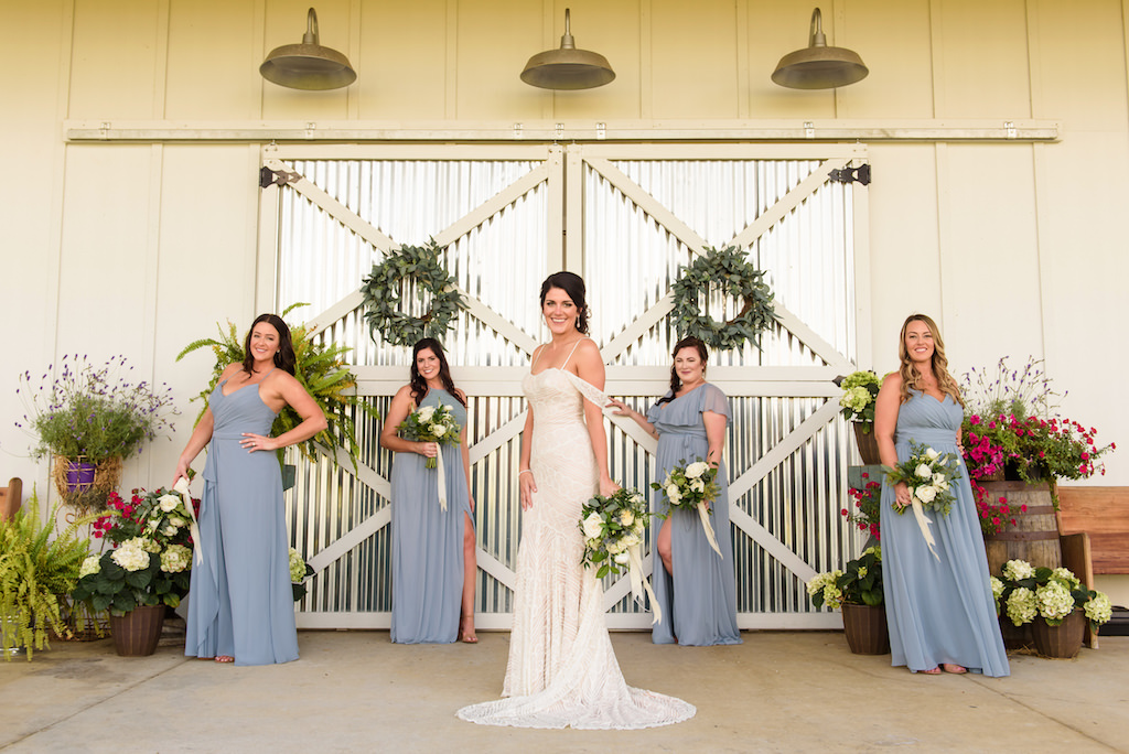 Florida Bride and Bridesmaids in Mix and Match Powder Blue Dresses, Bride in Wtoo Watters Fitted Off the Shoulder Lace Wedding Dress Outside of White Barn | Tampa Bay Rustic Wedding Venue Covington Farms