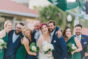 Florida Bride, Groom, Bridesmaid in Emerald Green Dresses Holding White Tulip Floral Bouquets, Groomsmen in Blue Suits | St. Pete Wedding Photographer Kera Photography | Tampa Bay Wedding Hair and Makeup Artist Destiny and Light Hair and Makeup