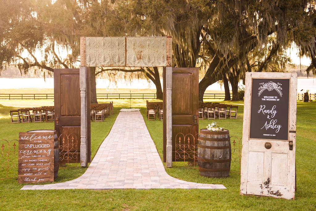 Rustic Outdoor Country Chic Wedding Ceremony Decor, Wooden Door Entryway, Wooden Barrels, Custom Wooden Welcome Sign, White Door with Chalkboard Personalized Sign | Tampa Bay Wedding Venue Covington Farms | Tampa Wedding Planner Parties A'La Carte