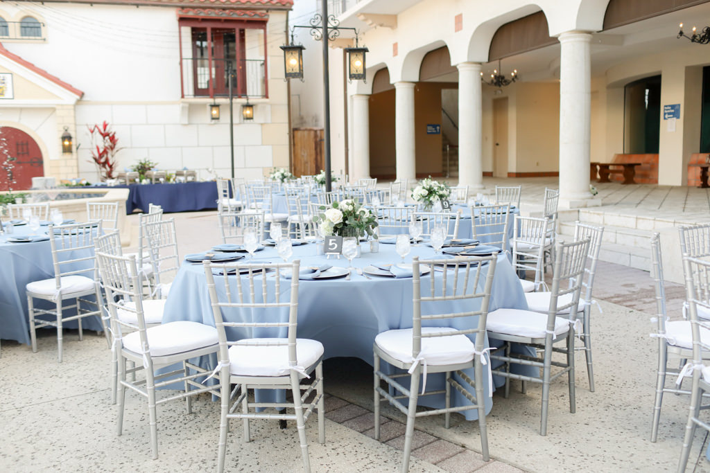 Rustic Elegant Wedding Reception Courtyard Decor, Round Tables with Dusty Pale Blue Linens, Silver Chiavari Chairs, Low Floral Centerpieces | Wedding Photographer Lifelong Photography Studios | Wedding Venue Bishop Museum of Science and Nature | Wedding Planner Kelly Kennedy Weddings and Events