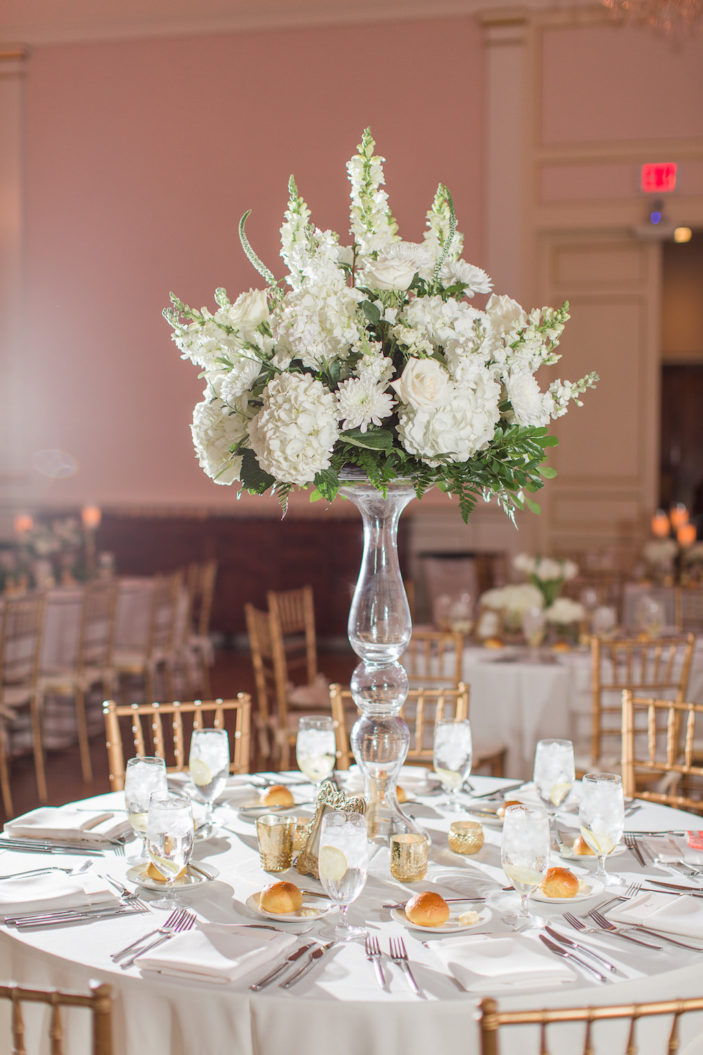 Classic, Romantic, Elegant Timeless Ballroom Wedding Reception Decor, Round Tables with White Linens, Gold Chiavari Chairs, Tall White Hydrangeas, Roses and Snapdragon Floral Centerpiece on Tall Glass Skinny Vase | St. Petersburg Wedding Venue Museum of Fine Arts | Wedding Rentals Olympia Catering