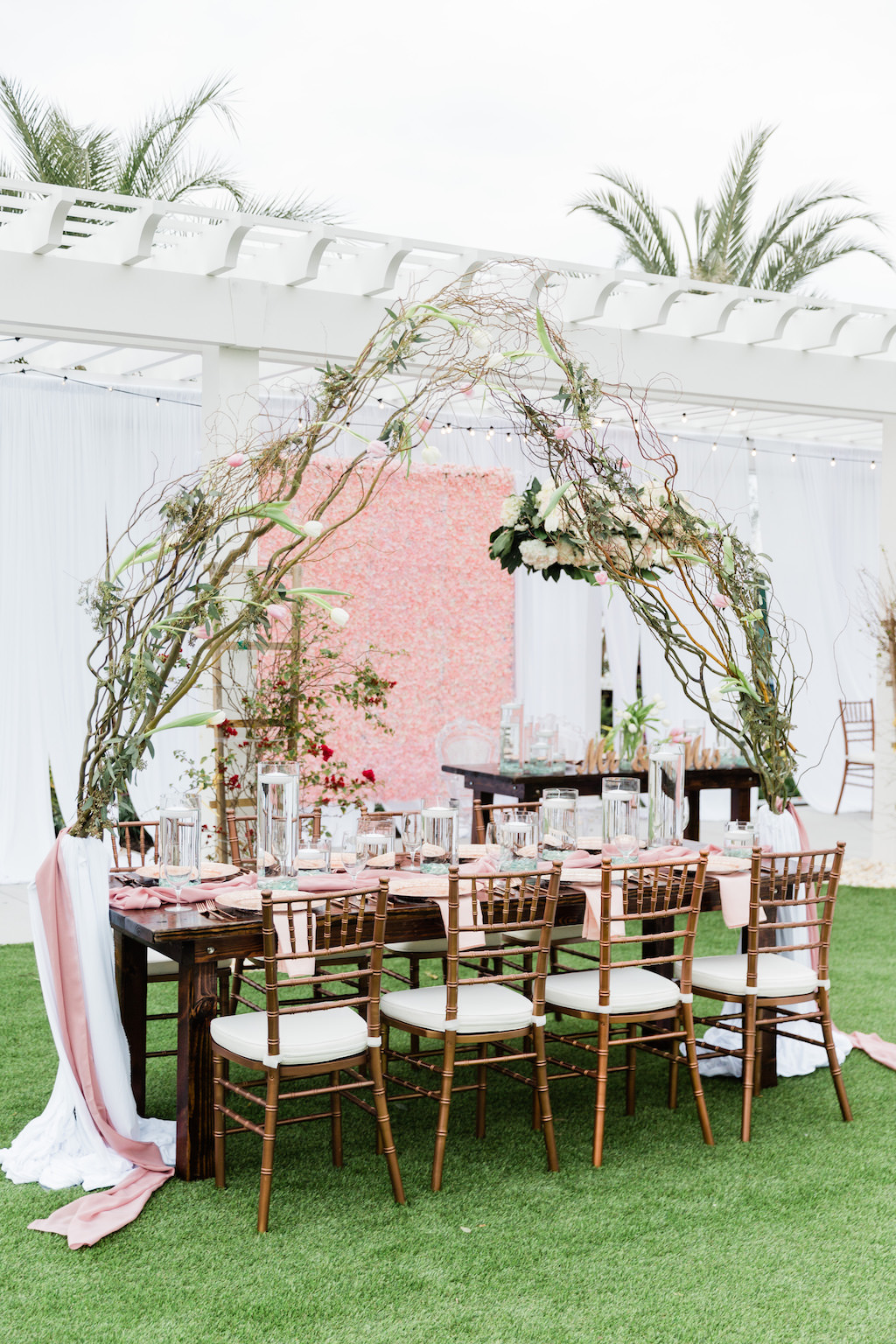 Modern Florida Bride Whimsical Garden Wedding Decor and Reception under Gazebo, Pink Floral Boxwood Wall, White Draping, Hanging Floral Arrangement, Long Feasting Tables. Rose Gold Chiavari Chairs, Floral Curly Willow Arches, | Tampa Bay Wedding Planner Special Moments Event Planning | Tampa Bay Wedding Florist Gabro Event Services | Tampa Bay Wedding Rentals A Chair Affair Wall, White Draping, Hanging Floral Arrangement, Long Feasting Tables. Rose Gold Chiavari Chairs, Floral Curly Willow Arches, Sweetheart Table with Ghost Acrylic Chairs, Outdoor Dance floor | Tampa Bay Wedding Planner Special Moments Event Planning | Tampa Bay Wedding Florist Gabro Event Services | Tampa Bay Wedding Rentals A Chair Affair | Tampa Bay Hair and Makeup Artists Femme Akoi | Tampa Bay Couture Wedding Dress Boutique Isabel O'Neil Bridal Collection |