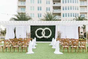 Modern, Garden Inspired Outdoor Wedding Ceremony, Gazebo Alter, Luxurious Infinity Ring Hanging Floral Arrangement with White Orchids, Dark Green Boxwood Wall, Wood Cross Back Chairs, Draping | Tampa Bay Wedding Planner Special Moments Event Planning | Tampa Bay Wedding Florist and Rentals Gabro Event Services