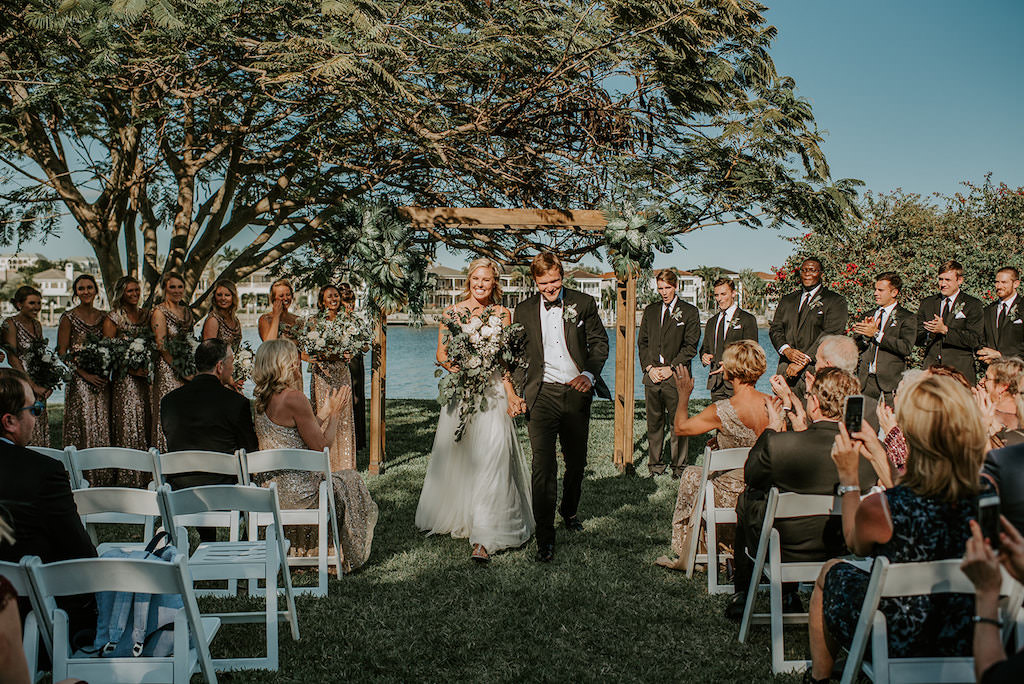 Florida Bride and Groom Wedding Ceremony Recessional Exit, Bride Holding Organic Greenery and White, Ivory Floral Bouquet | Tampa Wedding Venue Davis Islands Garden Club