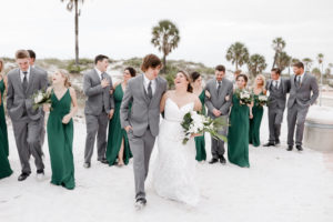 Florida Bride and Groom, Bridesmaids in Long Matching Green Dresses, Groomsmen in Grey Suits Fun Wedding Party Photo on Beach | Tampa Bay Wedding Photographer Lifelong Photography Studios