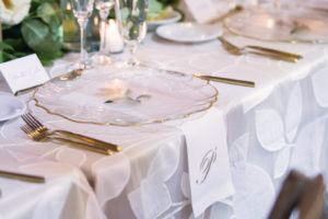 Modern Elegant Tuscan Inspired Wedding Reception Decor, Clear Glass and Gold Rimmed Chargers, Gold Silverware, Floral Tablecloth and Monogram White Linens | Tampa Bay Wedding Photographer Carrie Wildes Photography | Tampa Wedding and Event Rentals by Kate Ryan Event Rentals