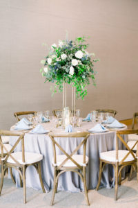 Marry Me Tampa Bay Before 5 Networking Event, St. Pete Venue Crawl | Wedding Tablescape with Baby Blue Linens and Greenery with Blue and White Florals with Crossback Wooden Farm Chairs