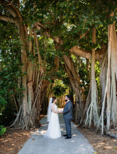 Outdoor Tampa Bay Bride and Groom First Look Wedding Portrait Under Banyan Trees | Sarasota Wedding Venue Marie Selby Botanical Gardens