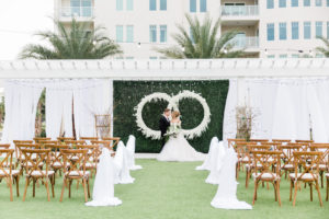 Modern, Elegant Florida Bride and Groom, At Garden Inspired Outdoor Wedding Ceremony, Gazebo Alter, Luxurious Infinity Ring Hanging Floral Arrangement with White Orchids, Dark Green Boxwood Wall, Wood Cross Back Chairs, Draping | Tampa Bay Wedding Planner Special Moments Event Planning | Tampa Bay Wedding Florist and Rentals Gabro Event Services