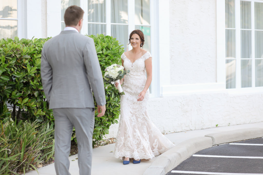Florida Bride and Groom First Look Wedding Portrait, Bride in Lace Off the Shoulder Fitted Fitted Wedding Dress and Something Blue Suede Pointed Shoes Holding White, Ivory and Greenery Floral Bouquet | Wedding Photographer Lifelong Photography Studios
