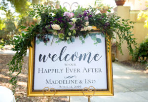 Sarasota Elegant, Classic Wedding Ceremony Decor, Gold Frame with White and Black Font Welcome Sign, Purple, Lilac, Ivory and Greenery Floral Arrangement