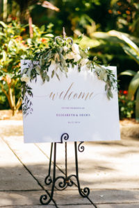 Simple Elegant Garden Inspired Wedding Ceremony White Welcome Sign with Greenery Garland and White Ivory Florals Decor