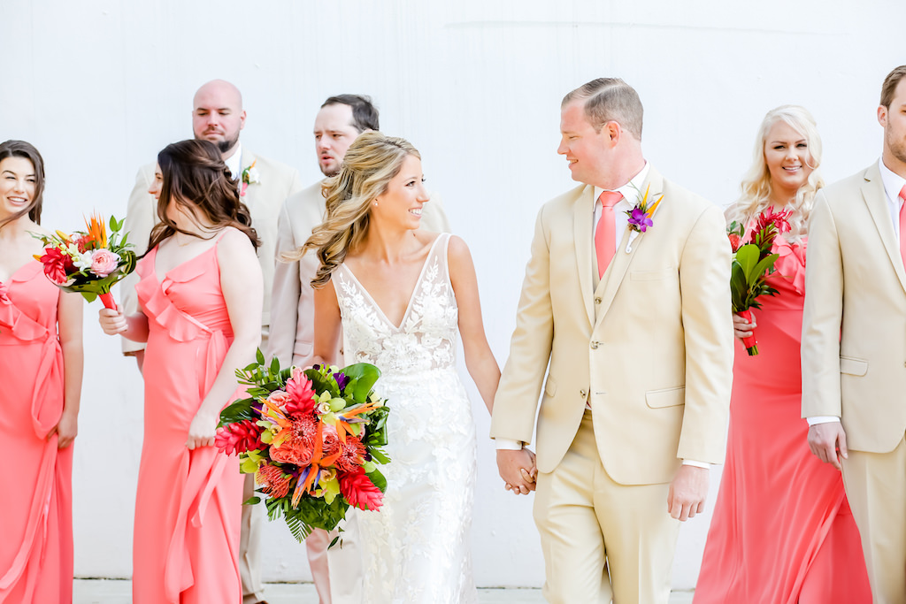 Elegant Florida Bride and Groom, Carrying Vibrant, Tropical Floral Bouquet, Colorful Island-Inspired Flowers, Bridal Party in Coral Pink Long Bridesmaid Dresses Portrait | Tampa Bay Wedding Photographer Lifelong Photography Studios | Tampa Bay Wedding Hair and Makeup Artist Michele Renee The Studio | South Tampa Wedding and Bridal Party Dress Shop Bella Bridesmaids