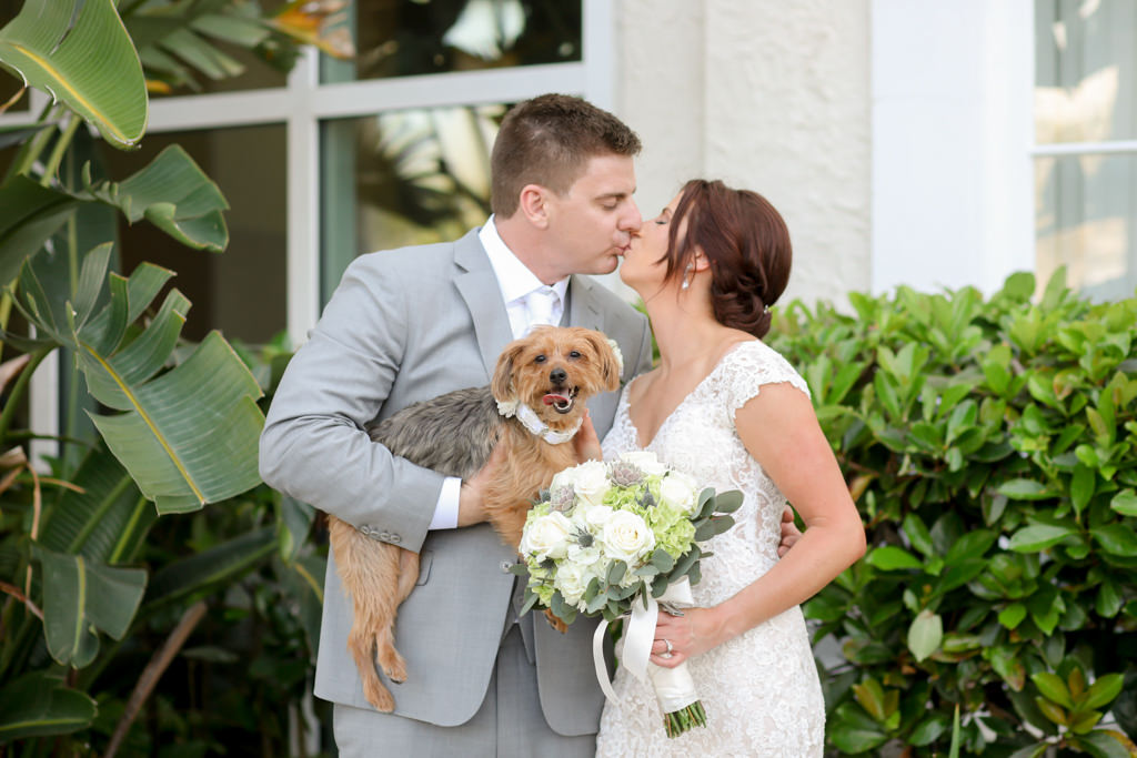 Romantic Intimate Bride and Groom with Dog Kissing, Bride Holding White, Ivory, Succulent and Greenery Floral Bouquet | Sarasota Wedding Photographer Lifelong Photography Studios | Kelly Kennedy Weddings and Events