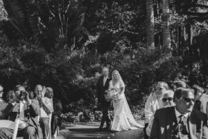 Black and White Bride and Father Walking Down the Wedding Ceremony Aisle Photo