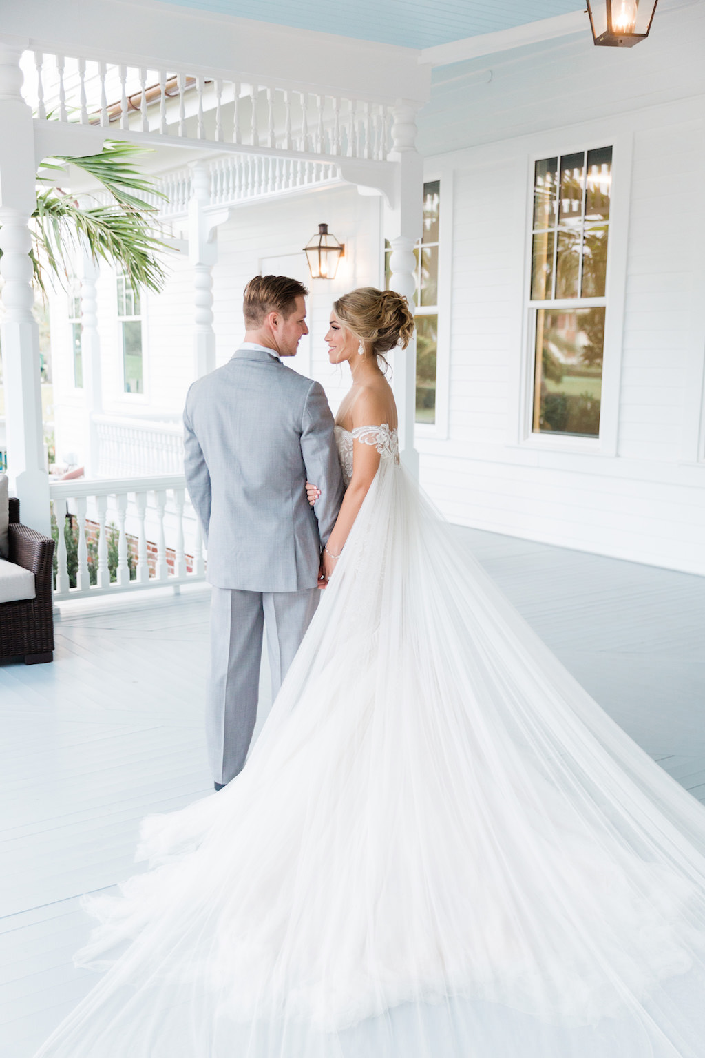 Romantic, Modern Florida Bride and Groom, Wearing White Couture Wedding Dress with Long Tulle Cape | Tampa Bay Hair and Makeup Artists Femme Akoi | Tampa Bay Couture Wedding Dress Boutique Isabel O'Neil Bridal Collection |
