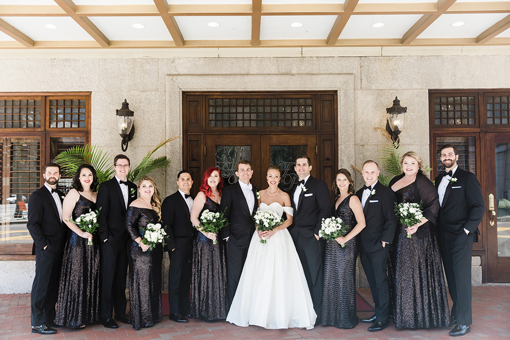 Classic Florida Bride and Groom First Look outside Hotel Floridan, Black-Tie Formal Tuxedo, White Wtoo by Watters Wedding Dress, Mimi, Bridesmaids in Dark Sequined Long Mix matched Dresses, Holding White Floral Bouquets with Greenery, Outside Hotel Floridan in Tampa