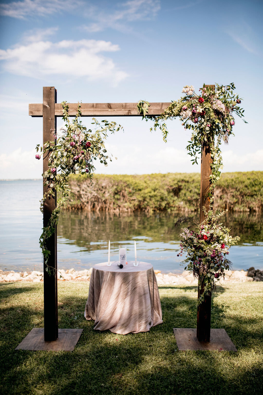 Romantic Waterfront Wedding Ceremony Portrait with Wooden Arch with Purple, Blush Pink and Greenery Floral Arrangements Waterfront Portrait | Wedding Venue The Resort at Longboat Key Club