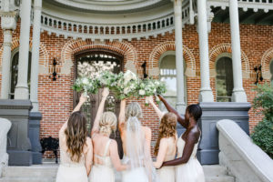 Florida Bride and Bridesmaids Bridal Party Portrait in Mix and Match Neutral Dresses Holding Greenery and Ivory Floral Bouquets | Tampa Bay Wedding Photographer Lifelong Photography Studio | University of Tampa