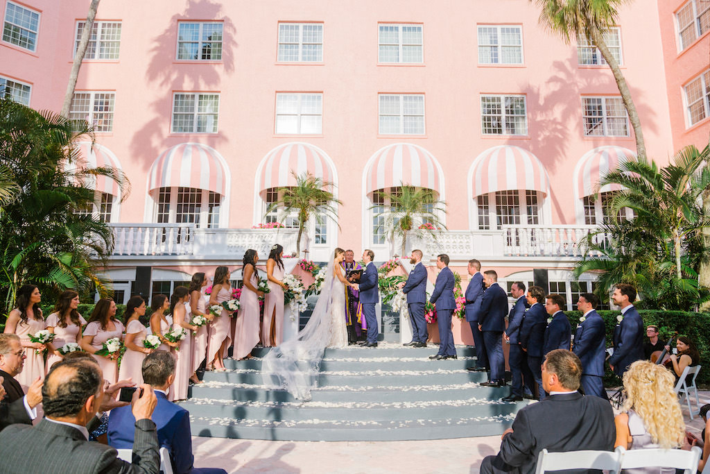 Florida Bride and Groom Exchanging Vows During Wedding Ceremony Portrait in Hotel Courtyard | Historic Waterfront St. Pete Beach Wedding Venue The Don Cesar