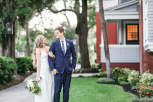 Florida Bride and Groom Wedding Portrait, Bride in Lace Fitted V Neckline with Spaghetti Strap Wedding Dress Holding Garden Inspired Greenery and Ivory Floral Bouquet, Groom in Blue Suit | Tampa Bay Wedding Photographer Lifelong Photography Studio