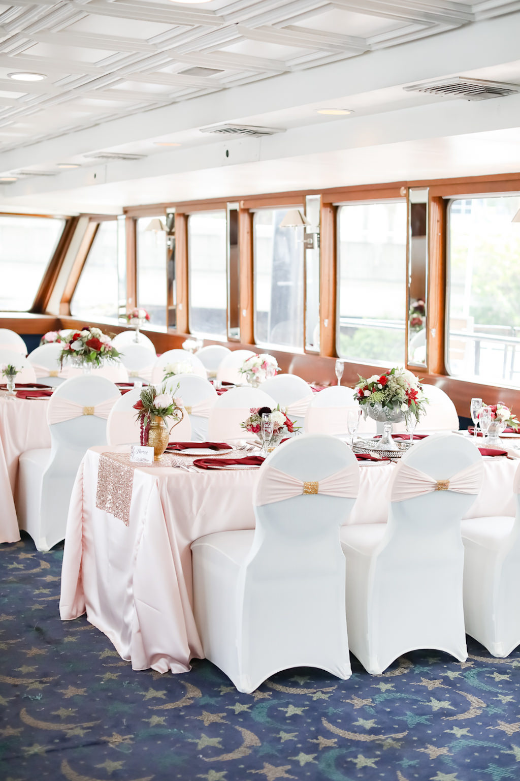 Classic Elegant Wedding Reception Decor, Long Tables with Blush Pink Silk Linens, White Linen Covered Chairs with Blush Pink Sash, Low Floral Centerpieces | Tampa Bay Wedding Photographer Lifelong Photography Studio | Clearwater Waterfront Wedding Venue Yacht Starship | Wedding Rentals Kate Ryan Event Rentals