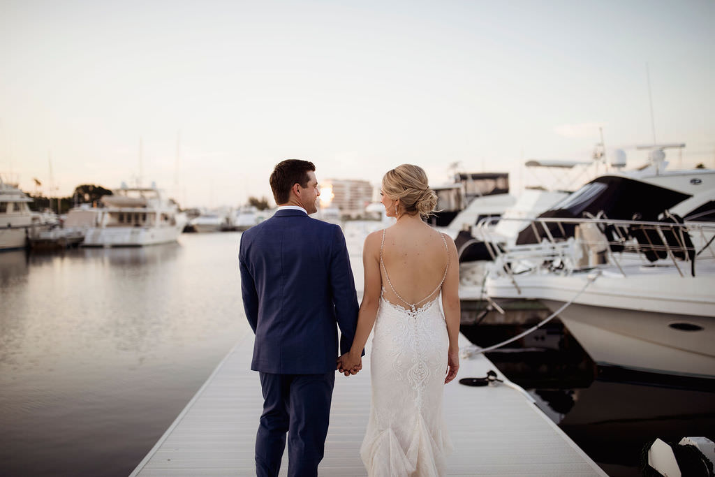Waterfront Yacht Boat Dock Bride and Groom Holding Hands Wedding Portrait | Tampa Bay Wedding Venue The Resort at Longboat Key Club