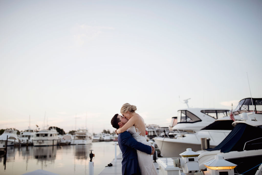 Waterfront Yacht Boat Dock Intimate Kissing Bride and Groom Wedding Portrait | Tampa Bay Wedding Venue The Resort at Longboat Key Club