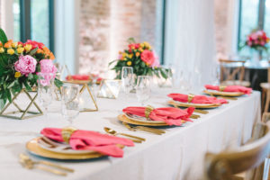 Modern Colorful Wedding Reception Decor, Gold Chargers and Plates, Bright Pink Linens with Gold Napkin Rings, Tropical Colorful Purple, Pink, Yellow and Orange Flowers and Greenery Centerpiece on Gold Geometric Stand | Tampa Bay Wedding Photographer Kera Photography | St. Pete Wedding Linens and Tabletop Rentals Kate Ryan Event Rentals | Florida Wedding Planner UNIQUE Weddings & Events | Tampa Wedding Florist and Rentals Gabro Event Services