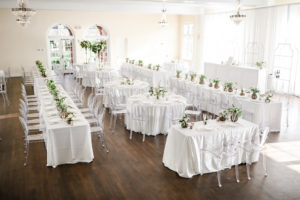 Classic Neutral Wedding Reception Decor, Long Feasting Tables and Round Tables with White Linens, Low Gold Vases with Ivory and Greenery Florals, Clear Ghost Acrylic Chairs | Tampa Bay Wedding Photographer Lifelong Photography Studio | Wedding Rentals Kate Ryan Event Rentals | Historic South Tampa Wedding Venue The Orlo