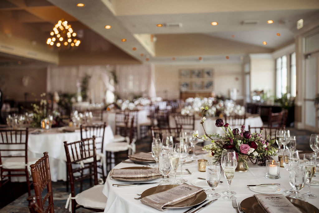 Elegant Classic Wedding Reception Decor, Round Tables with Mahogany Chiavari Chairs, White Linens, Low Gold Vase with Lilac, Dark Red, Purple, and Greenery Floral Centerpiece | Tampa Bay Waterfront Wedding Venue The Resort at Longboat Key Club