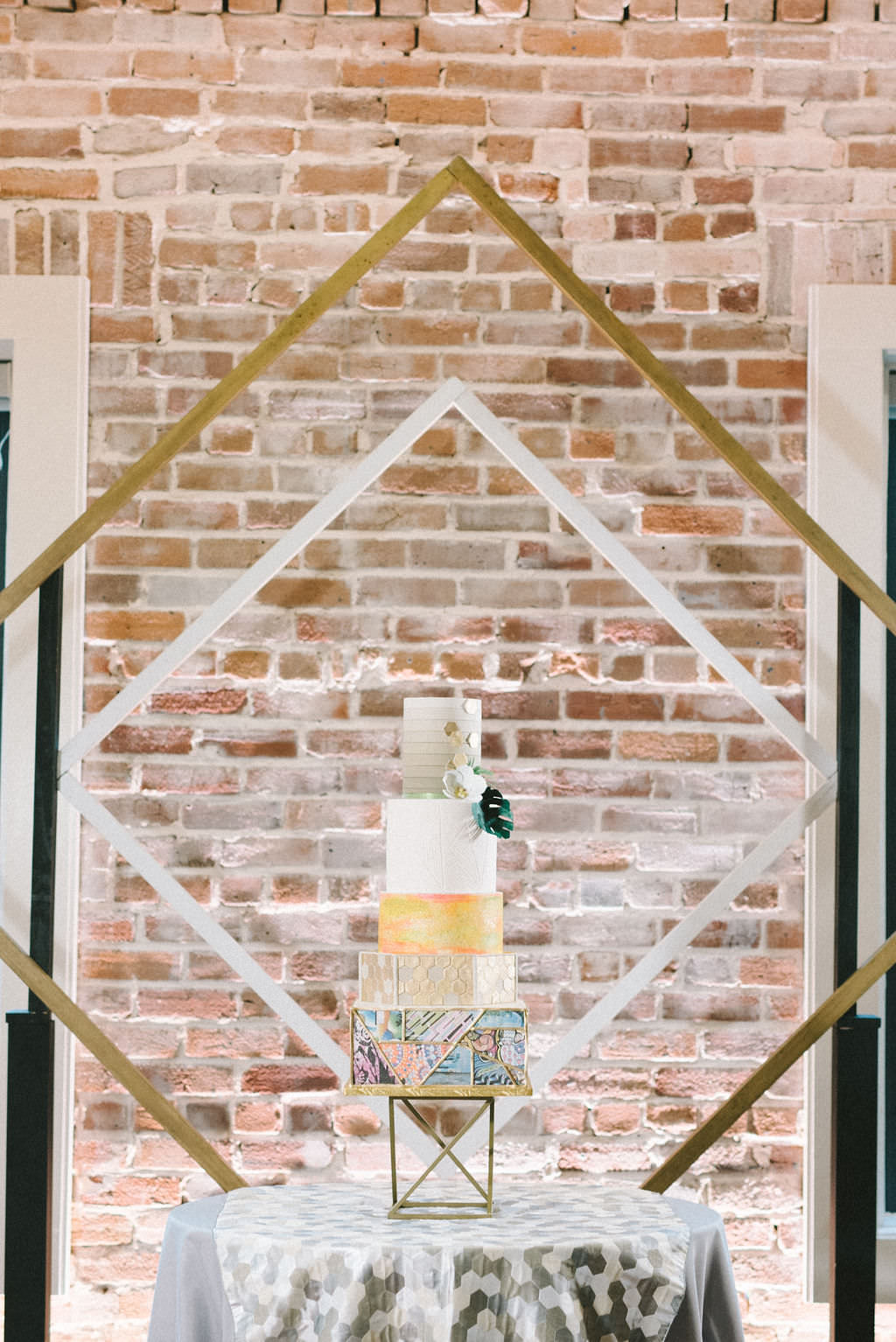 Modern Tropical Unique Five Tier White, Gold, Yellow, Pink and St. Pete Mural Wedding Cake, Gold Geometric Diamond Backdrop | Tampa Bay Wedding Photographer Kera Photography | Downtown St. Pete Wedding Venue Red Mesa Events | Florida Wedding Event Planner UNIQUE Weddings & Events | Wedding Cake The Artistic Whisk | Wedding Linens Kate Ryan Event Rentals | Wedding Decor Rentals Gabro Event Services