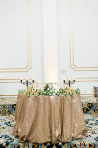 Gold Sequined Sweetheart Table, Mr and Mrs Letters, Black Candlestick Centerpiece with White Flowers and Greenery | Tampa Bay Wedding Planner Coastal Coordinating