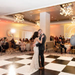 Romantic Bride and Groom First Dance Wedding Reception Portrait on Black and White Checkered Dance Floor, Modern Chandeliers | Clearwater Beach Wedding Venue Hyatt Regency Clearwater Beach | Clearwater Beach Wedding and Event Rentals by Gabro event Services
