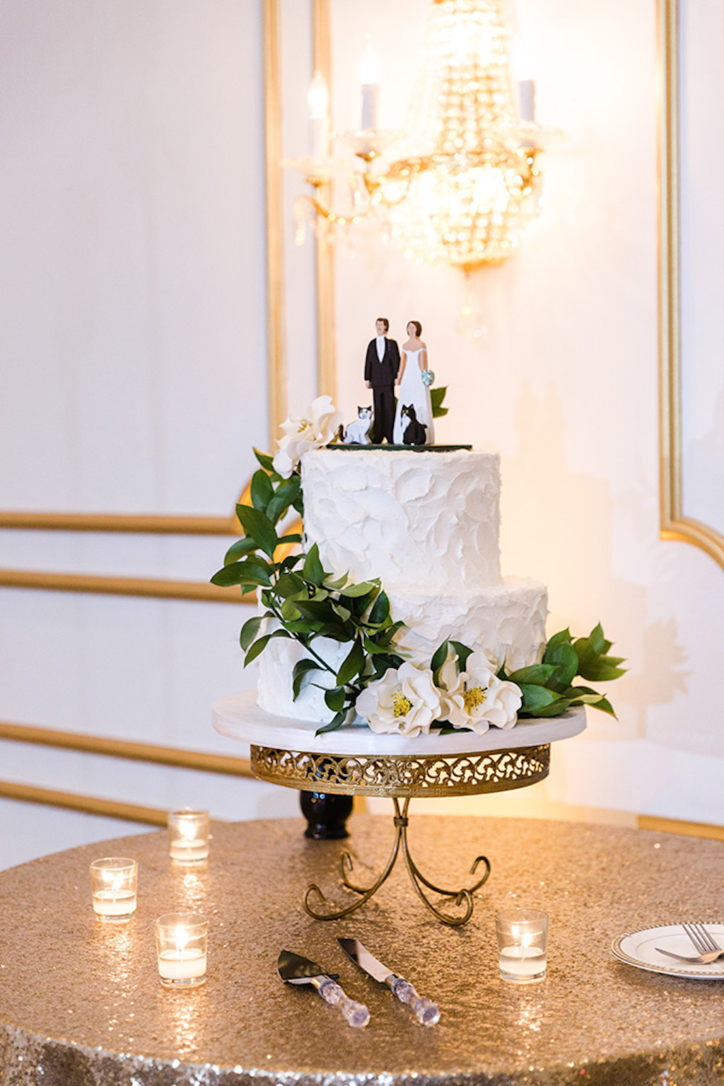 Elegant, White Two-tier textured Buttercream Wedding Cake with Edible Sugar Flower and Greenery Accents, Custom Cake Topper with Pets, Gold Sequined Cake Table cloth | Tampa Bay Wedding Cake Artists Alessi Bakery