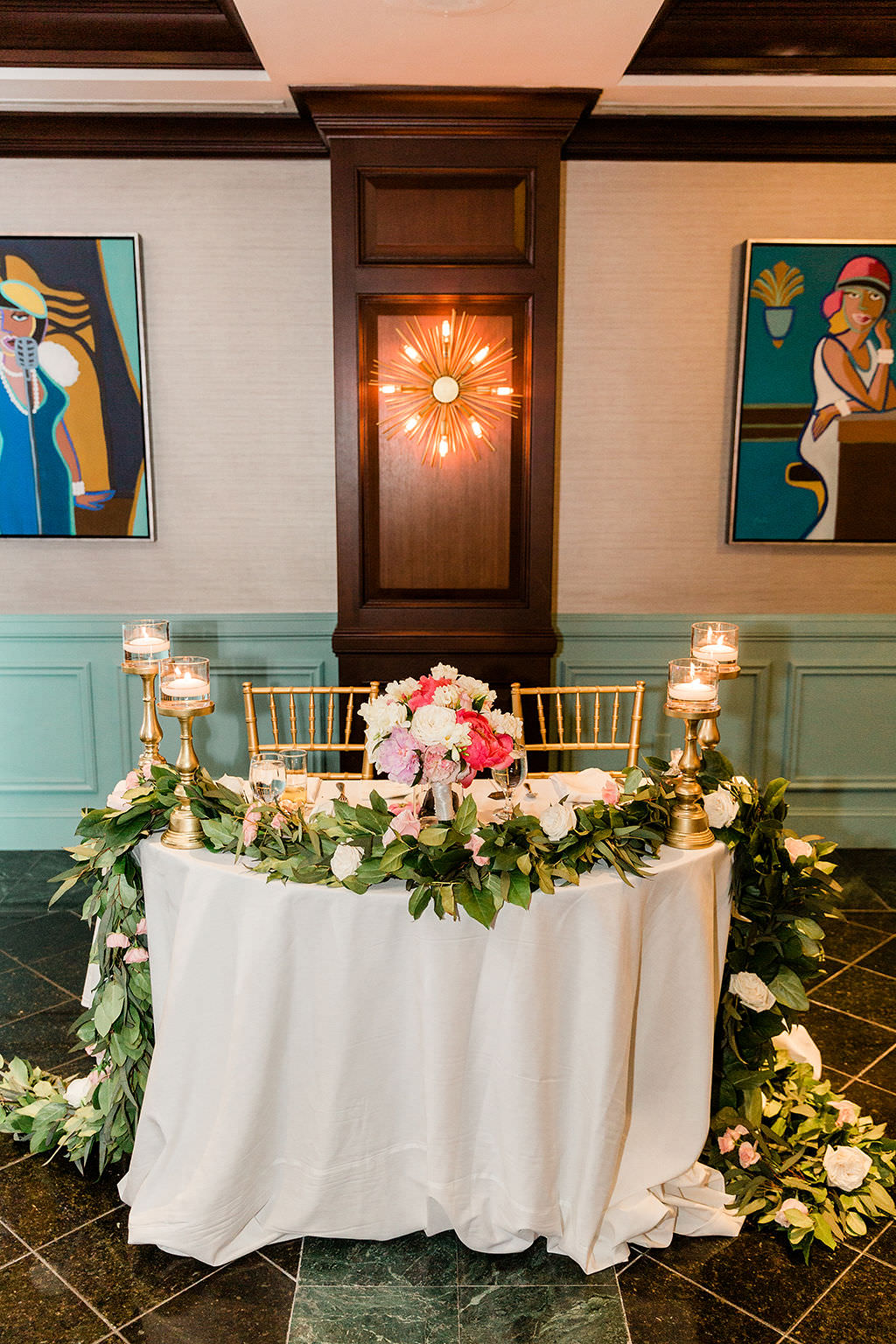 Elegant Tampa Bay Wedding Reception Decor, Sweetheart Table with White Linen, Greenery Garland and White Florals, Pink and Blush Pink Floral Arrangement and Gold Candlesticks, Gold Chiavari Chairs | Fred's Cellar at The Vinoy