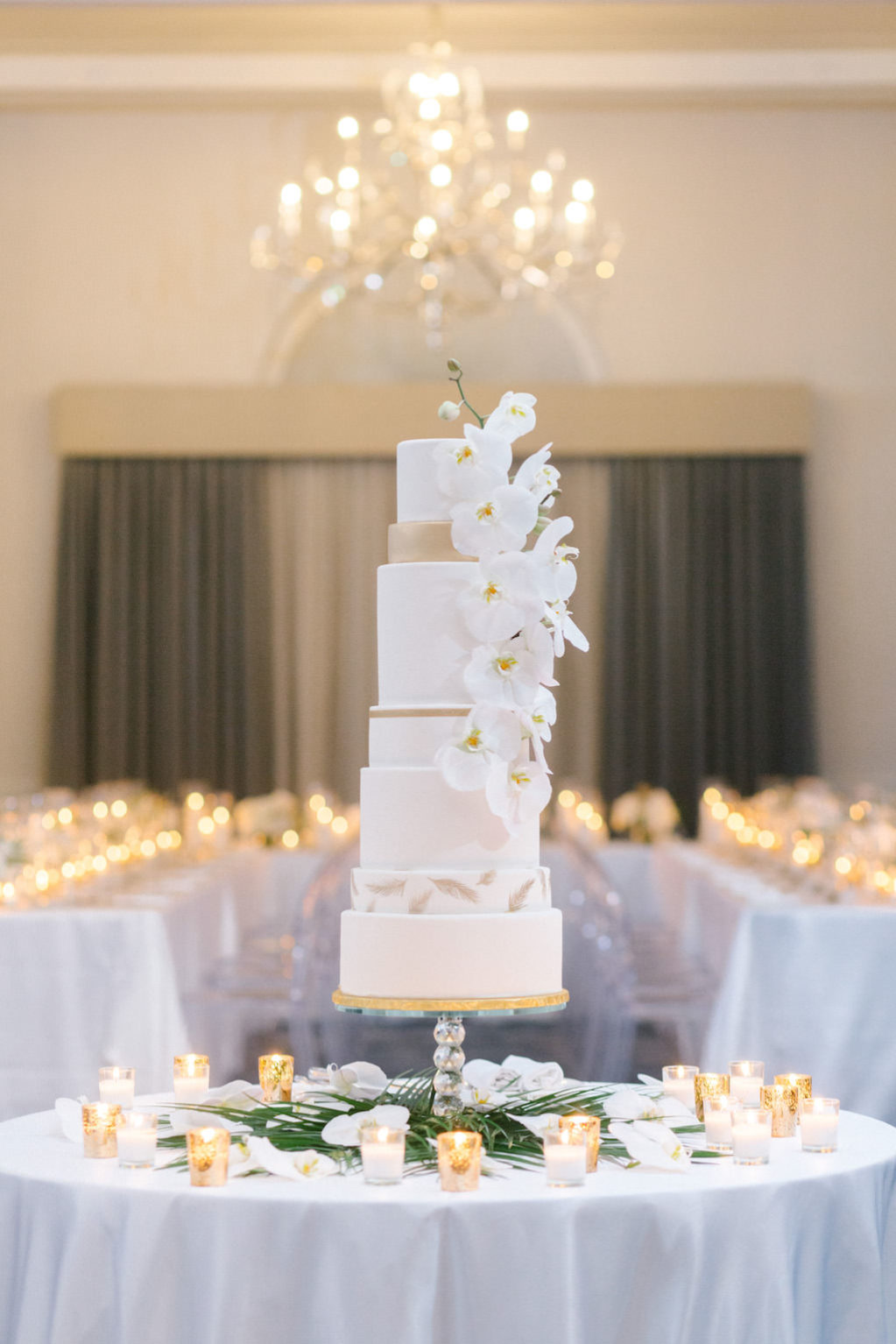 Elegant Classic Modern Seven Tier White and Gold Wedding Cake with Cascading White Real Orchid Flowers | Tampa Bay Wedding Baker The Artistic Whisk | Wedding Florist Bruce Wayne Florals | Wedding Rentals Kate Ryan Event Rentals