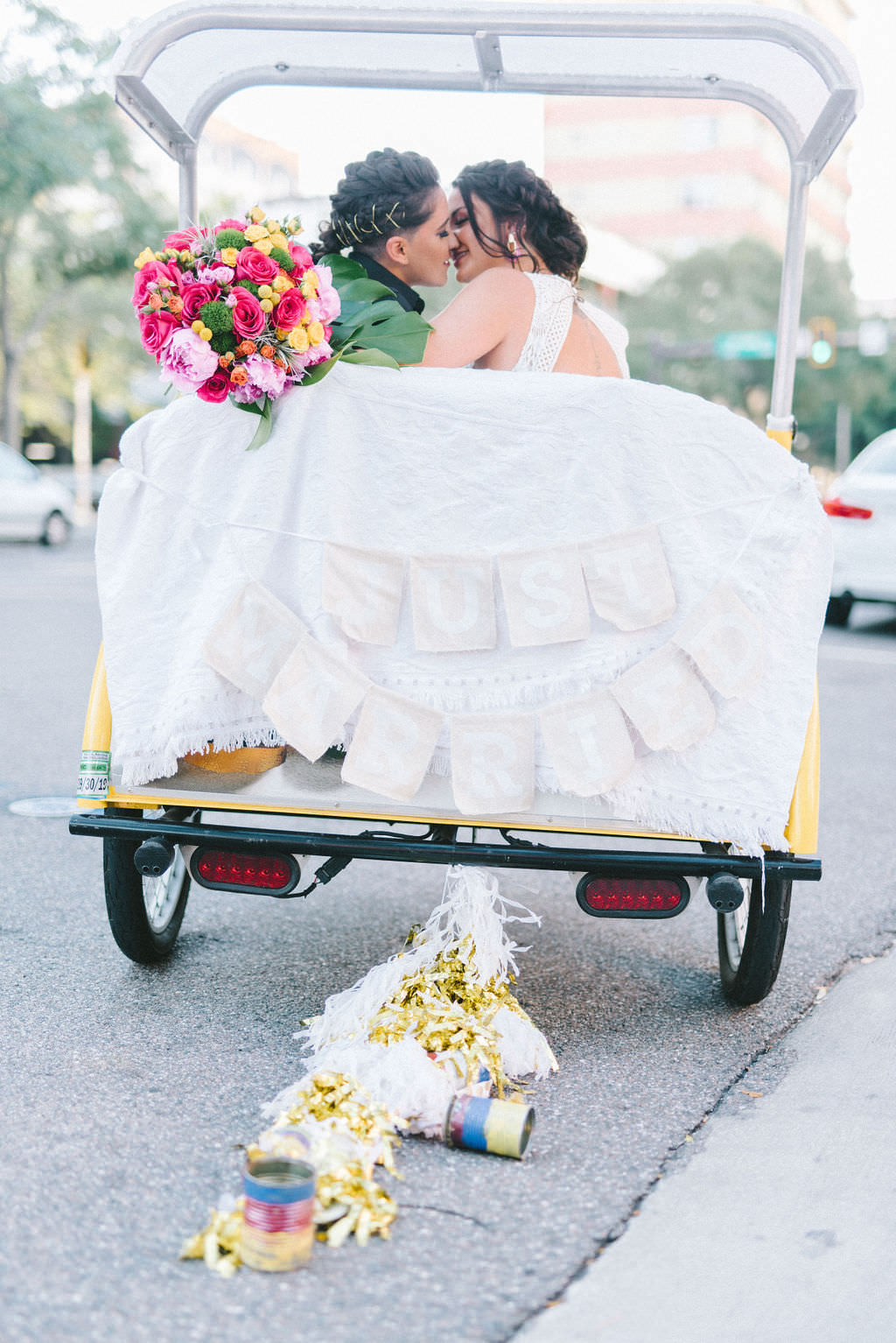 Outdoor Florida Lesbian Gay Wedding Portrait on St. Pete Pedicab with Colorful Pink, Yellow and Purple Flower Bridal Bouquet | Tampa Bay Wedding Photographer Kera Photography