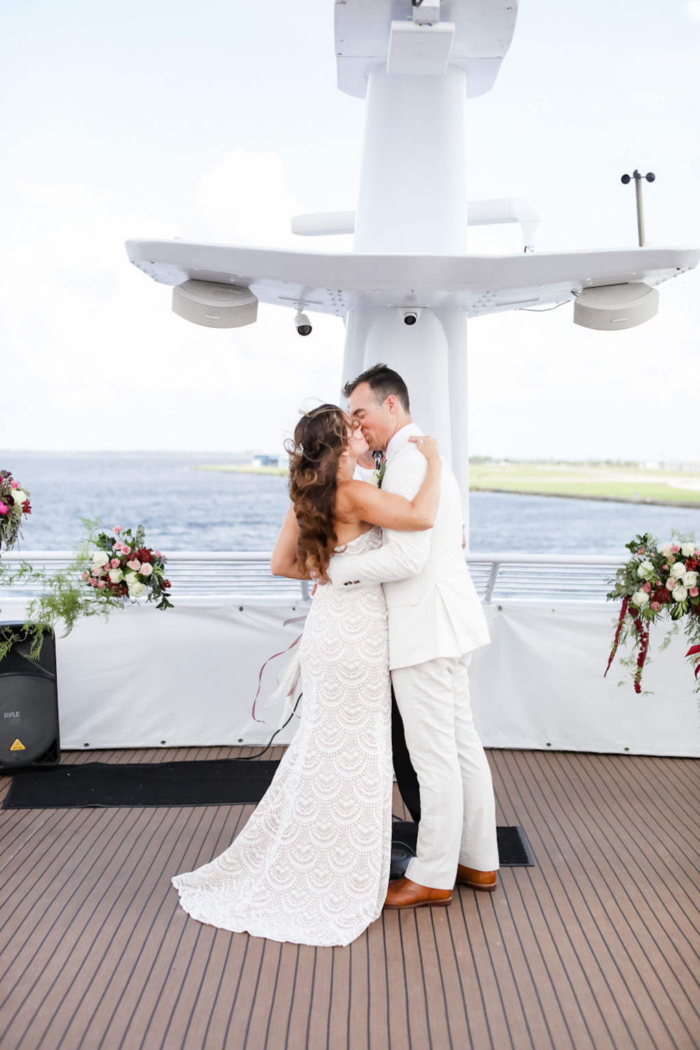 Florida Bride and Groom Exchanging First Kiss During Wedding Ceremony Portrait | Tampa Bay Wedding Photographer Lifelong Photography Studio | Clearwater Beach Waterfront Wedding Venue Yacht Starship