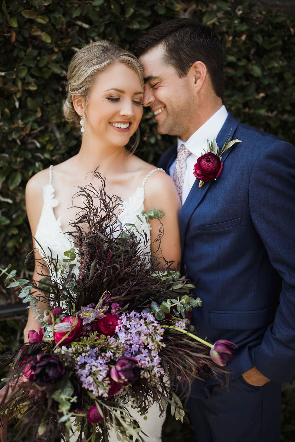 Tampa Bay Bride and Groom First Look Wedding Portrait, Bride Holding Unique Purple, Lilac, Plum and Greenery Floral Bridal Bouquet, Groom in Navy Blue Suit with Deep Dark Red Boutonniere