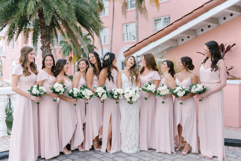 Modern Tropical Bride and Bridesmaids in Mix and Match Blush Pink Dresses Holding White Floral Bouquets Bridal Party Portrait | Tampa Bay Wedding Florist Bruce Wayne Florals | Waterfront Historic St. Pete Beach Wedding Venue The Don Cesar | Wedding Planner Parties A'La Carte