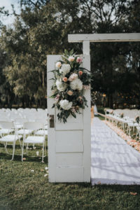 Rustic Chic Outdoor Wedding Ceremony Decor, Wooden Door Entry with White Hydrangeas, Blush Pink Roses and Greenery Floral Arrangement | Tampa Wedding Venue Rafter J Ranch | Wedding Planner Kelly Kennedy Weddings and Events