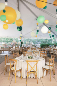 Whimsical Rustic Elegant Tent Wedding Reception Decor, Round Tables with Ivory Linens, Wooden Crossback Chairs, Green, Yellow and White Hanging Balloons | Tampa Bay Wedding Venue The Epicurean Hotel