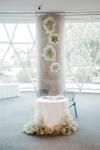 Elegant Whimsy Wedding Reception Decor, Round Sweetheart Table with Blush Pink Linen, White Baby's Breath Floral Arrangements, Hanging White Round Flowers | Tampa Wedding Planner and Florist John Campbell Weddings